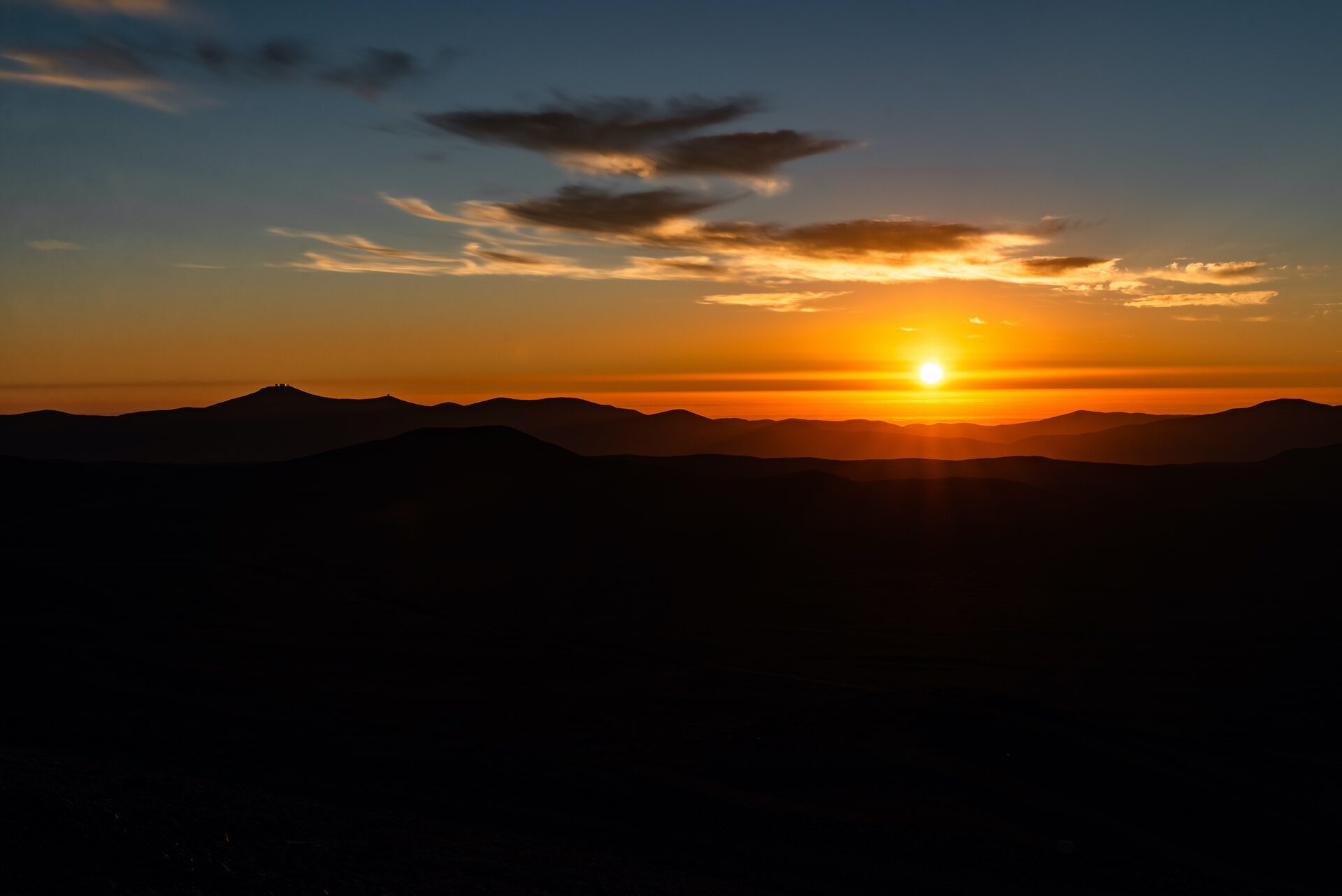 Sunset over the Atacama Desert with observatories on the distant ridge